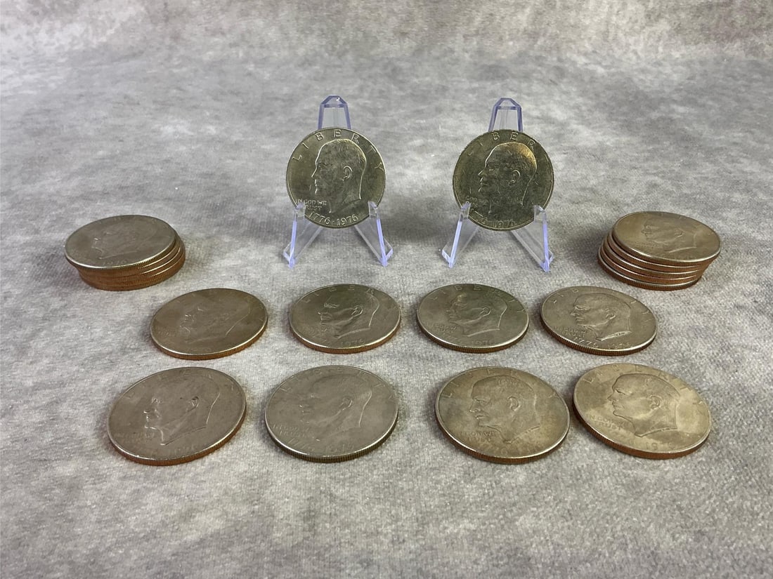 Eisenhower Dollar Coins: Lot of twenty 1976 Bicentennial Eisenhower dollar coins. All in good circulated condition. Each measures 1.5 inches in diameter.