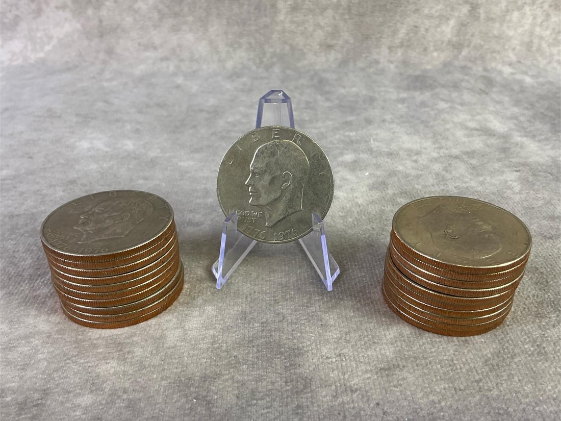 Eisenhower Dollar Coins: Lot of twenty-one 1976 Bicentennial Eisenhower dollar coins. All in good circulated condition. Each measures 1.5 inches in diameter.