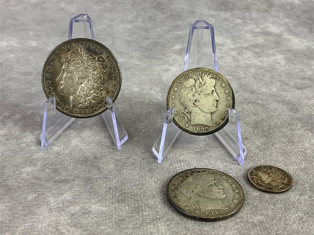 1883 Morgan Silver Dollar & More: 1883 Morgan Silver Dollar Coin, two Barber Half dollar coins, and 1940 Mercury Head Dime. All in circulated condition and contains 90 percent silver. Total weight 1.72 ozt.