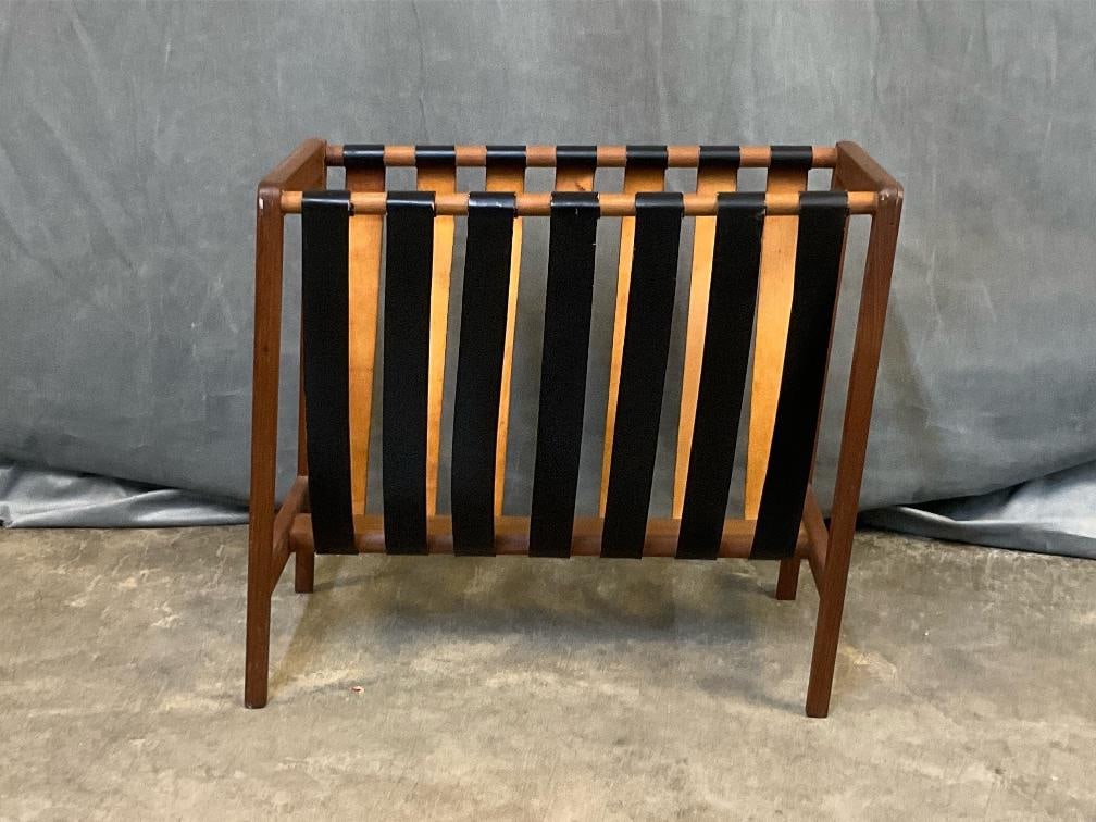 MCM Magazine Rack: MCM Circa 1960's Danish Modern leather and teak magazine rack. Wobbly with electrical tape repair to underside of leather straps and splitting and cracking to leather. Measures 20 inches wide x 11 x