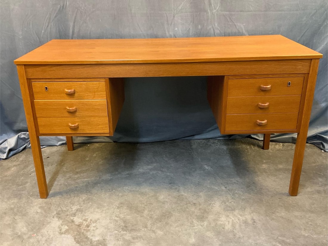 MCM Desk: MCM circa 1960's six drawer teak desk. Two top draws with working locks lock and key. Good condition. Measures 53 inches wide x 23.25 x 28.25 inches tall.