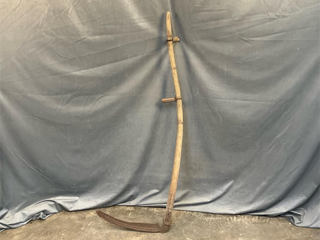 Hay Scythe: Late 19th - early 20th century antique hay scythe. Weathered and rusted blade with splits to the two handles. Measures 21 inches wide x 11 x 61 inches tall.