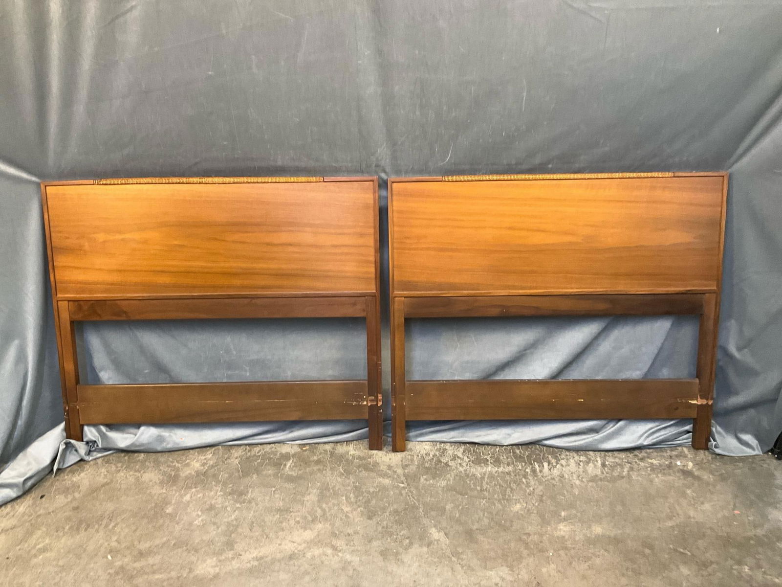 MCM Headboards: Two circa 1960 Frank Lloyd Wright inspired mahogany twin headboards with rattan top molding edge. Some wear to finish on lower stretcher. Good condition. Total dimensions; 40 inches wide x 1.25 x