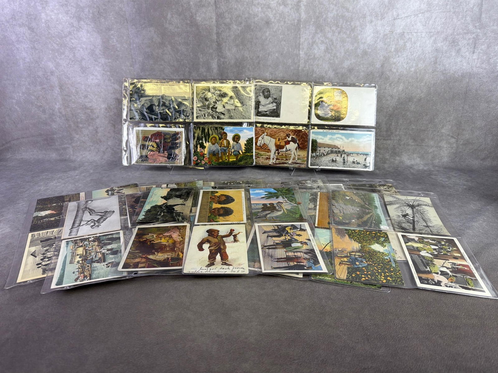Black Americana Postcards: Over 50 antique and vintage black Americana postcards including portraits, occasional, and lifestyle. All in good condition with some circulated and non. Each card is in a protective sleeve. Cards