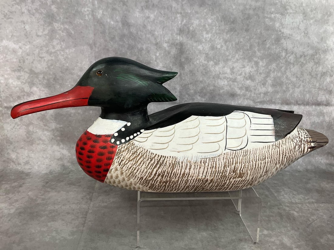 Hand Carved Decoy Duck: Vintage decoy duck. Wooden red breasted Merganser duck decoy, with painted details and glass eyes. A small amount of cracking of paint around neck, otherwise in good condition. Measures 19 inches