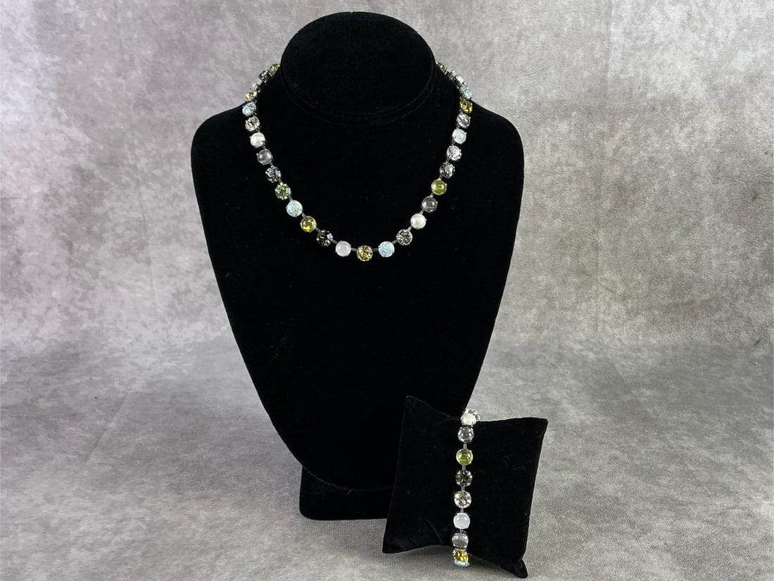 Sabika: Sabika necklace and bracelet featuring a single row of circular cut Swarovski stones in various colors. In good condition and handmade in Austria and Germany. Necklace measures 15 inches.