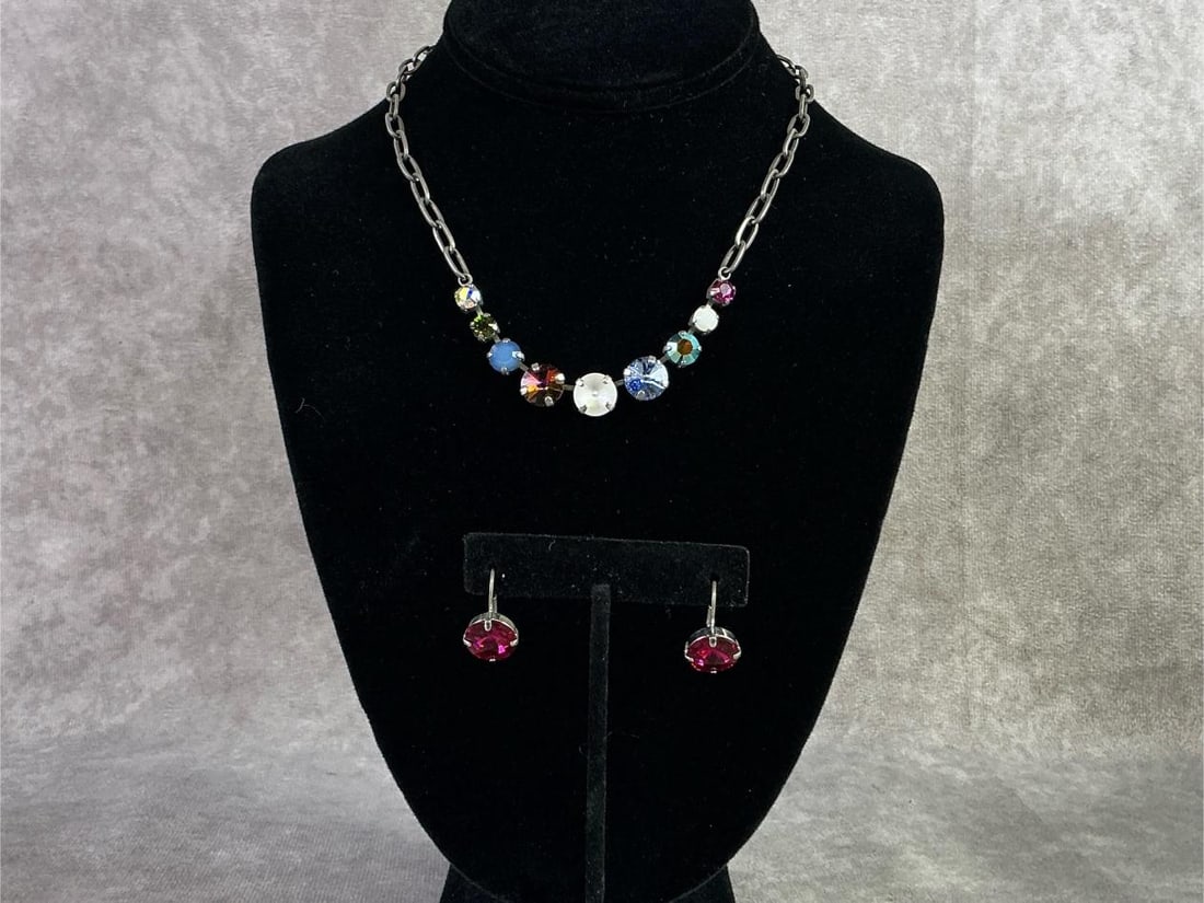 Sabika: Sabika necklace and earrings featuring a single row of circular cut Swarovski stones in various colors. In good condition and handmade in Austria and Germany. Necklace measures 16 inches.