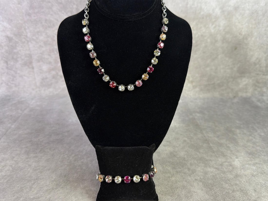 Sabika: Sabika necklace and bracelet featuring a single row of circular cut Swarovski stones in various colors. In good condition and handmade in Austria and Germany. Necklace measures 17 inches.
