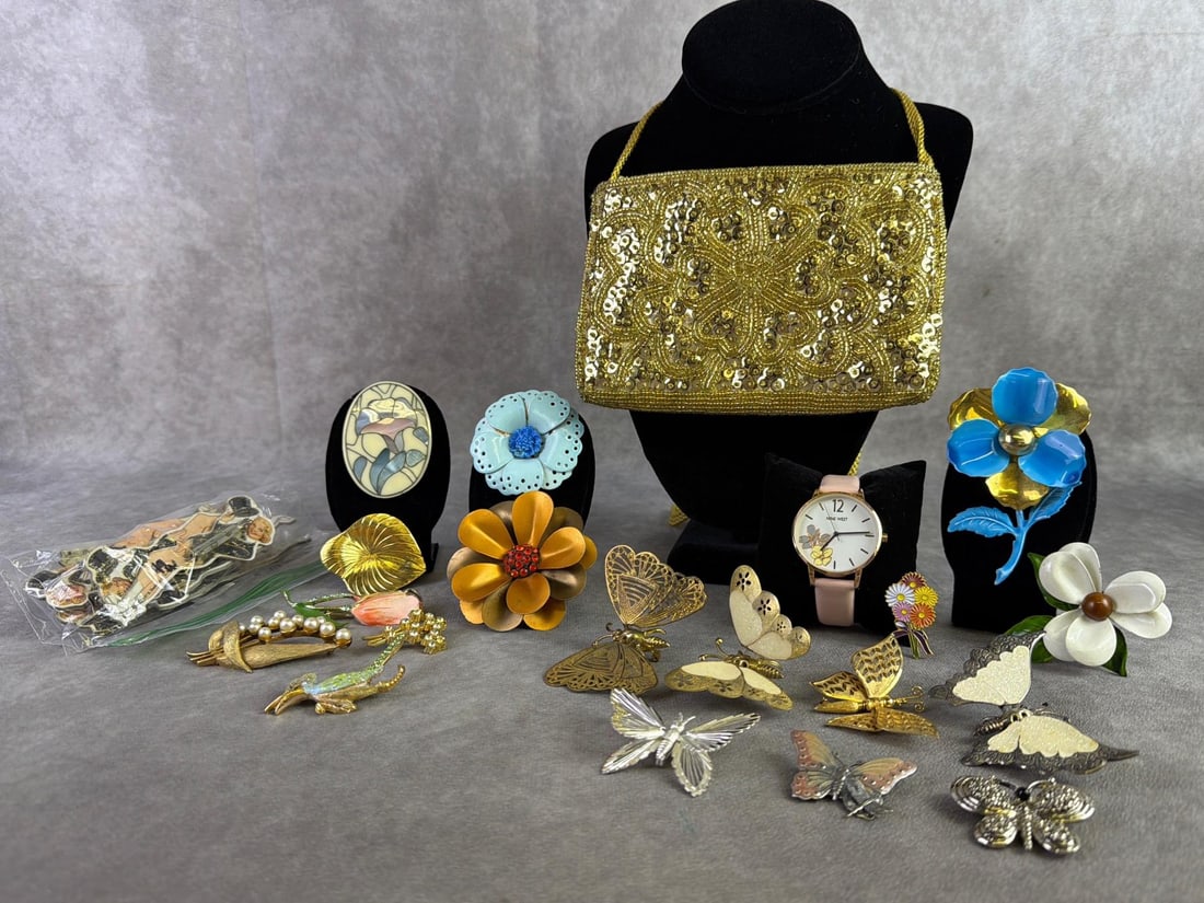 Costume Jewelry & More: Small lot of costume jewelry including seventeen brooches, eight Sonja Henie skating pins, Nine West floral watch, and La Regale vintage gold colored beaded and sequined purse. All in good condition.