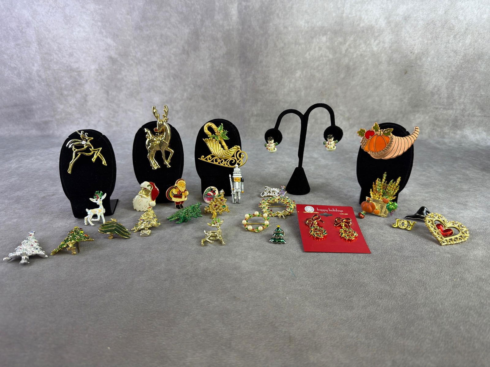 Seasonal Costume Jewelry: Lot of seasonal costume jewelry including two pairs of earrings and twenty brooches. All in good condition. Largest brooch measures 1 inch wide x 3 inches tall.