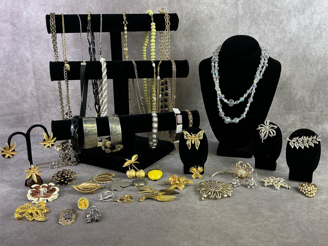 Costume Jewelry: Lot of costume jewelry including twenty seven brooches, one pair of earrings, six bracelets, and fifteen necklaces. Brands including Sarah Coventry, Avon, Monet, and more. All in good condition.
