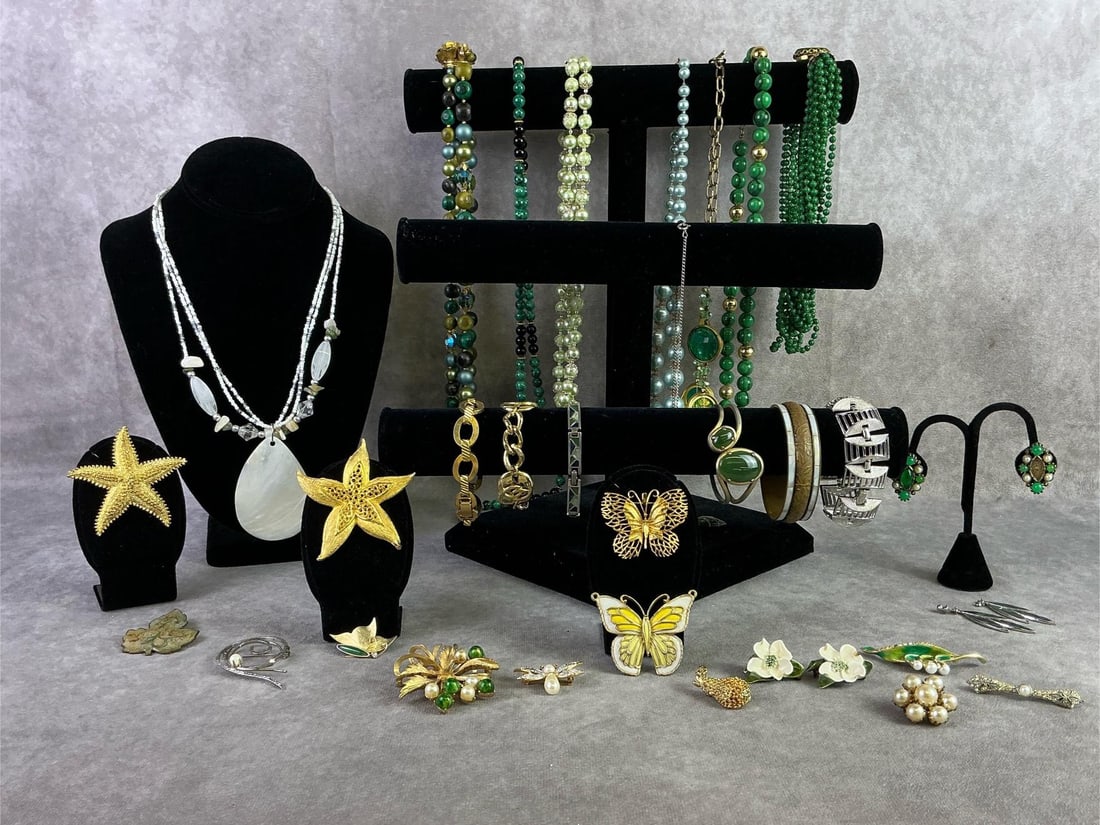 Costume Jewelry: Lot of costume jewelry including fourteen brooches, two pairs of earrings, six bracelets, and nine necklaces. Brands including Sarah Coventry, Avon, Monet, and more. All in good condition. Longest