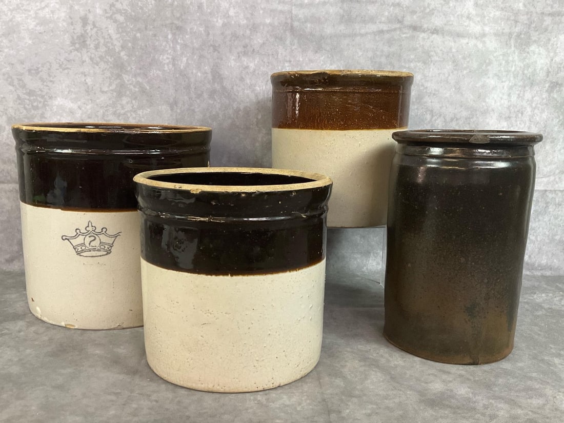 Stoneware Crocks: Four late 1800s to mid 1900s crocks. Number 2 Crown two toned 2 gallon crock, and two smaller 2 tone crocks. Includes salt glazed dark brown manganese crock. Dark brown crock has several chips in
