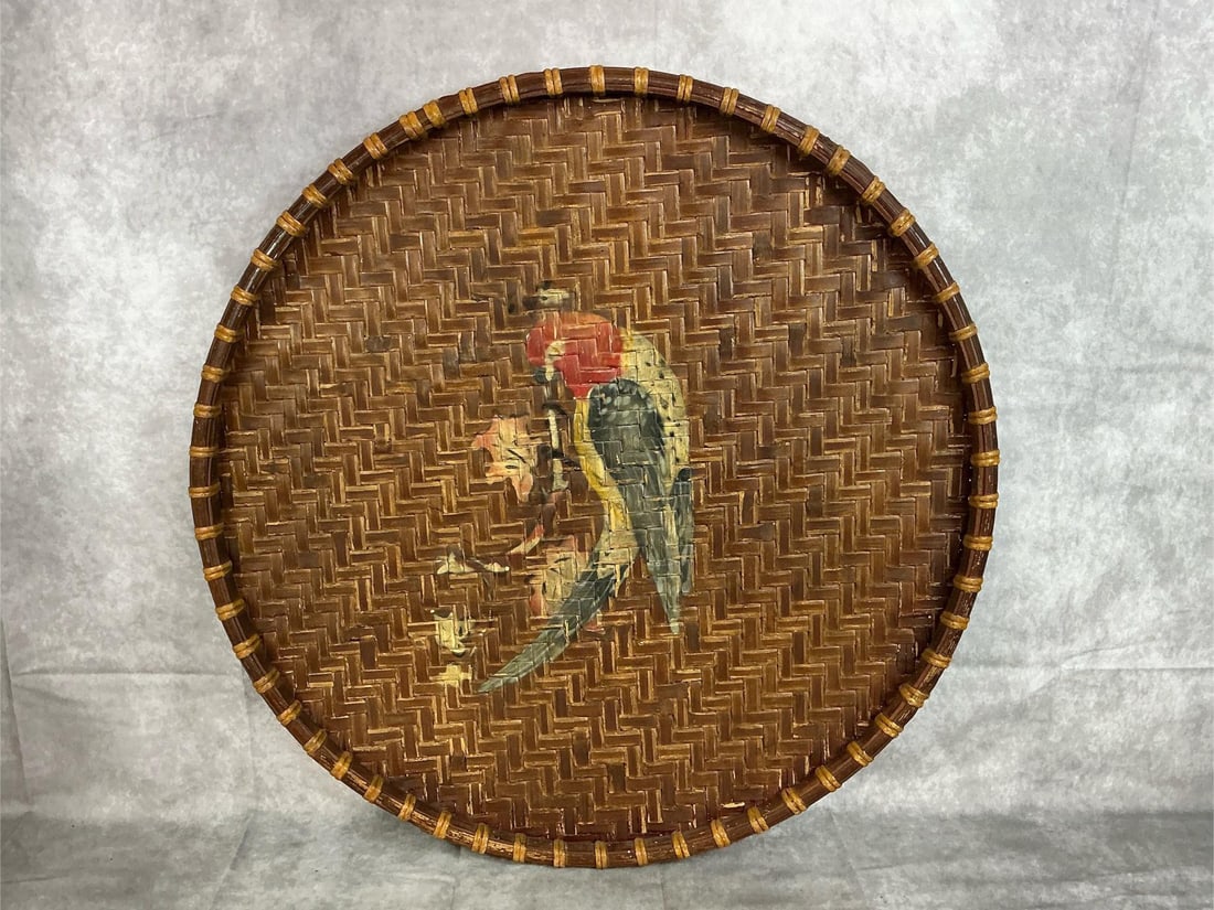 Parrot Basket: Early - middle twentieth century hand made splint wood serving tray/basket with centered painted parrot. Good condition. Measures 25.25 inches wide x 1 inch tall.