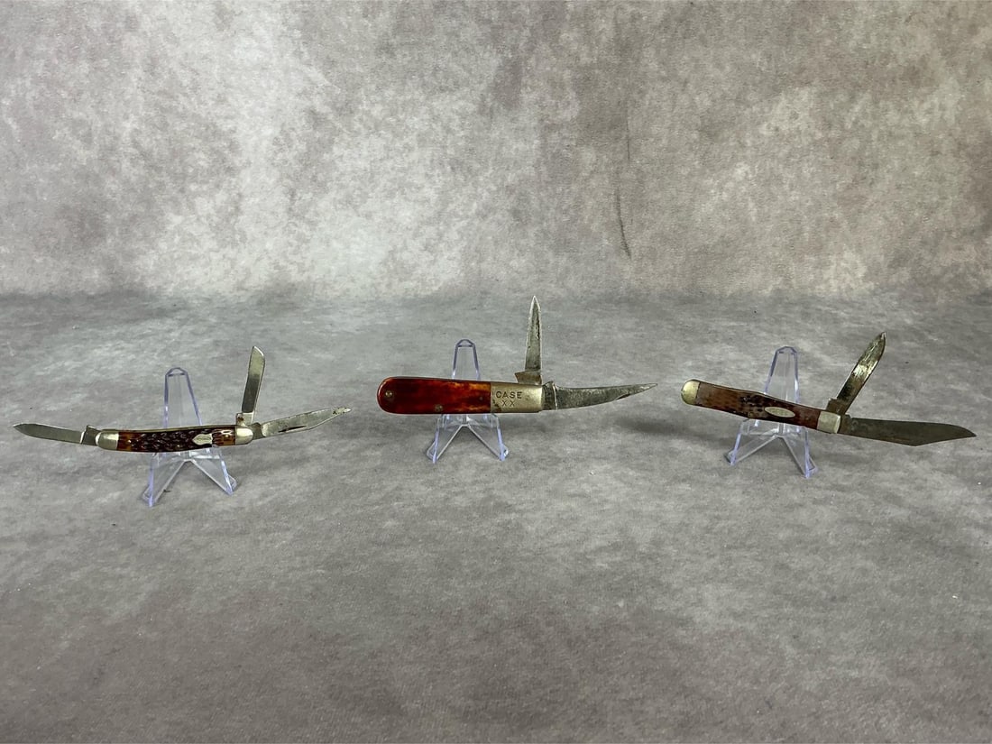 Case and Schrade Knives: Vintage 20th century group of three collectible pocket knives. One Case XX mid century vintage Barlow red bone pocket knife with blade wear, blade surface rust and discoloration with good snap. One