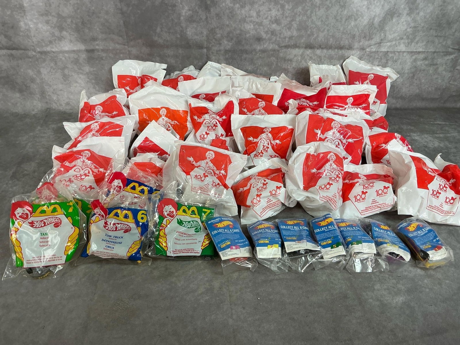 McDonald's "Surprise" Toys & Hot Wheels: Forty-two McDonald's Toys from 1990 to 2002. Thirty surprise toys are from Disney 100th Year of Magic and includes Pixar, Tarzan, and Winnie the Pooh. Twelve Hot Wheels toy vehicles. All in original