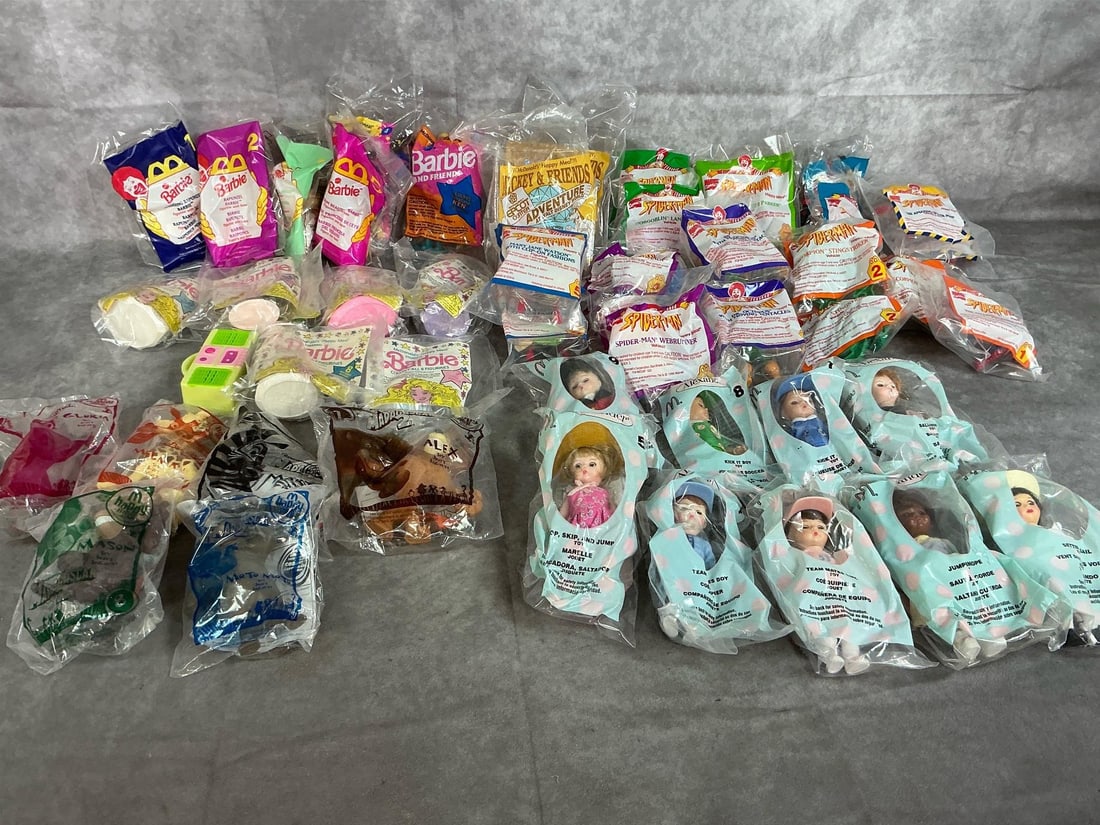 McDonald's Toys- Spiderman, Barbie & More: Forty-six 1990 to 2005 toys. McDonald's packaged toys include Spider-Man Comics, Madame Alexander Dolls, Barbie Figurines, and characters from Madagascar 2. All in good condition. Average package
