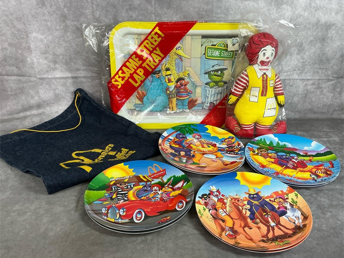 McDonald's Collectible Plates, Bag, & Doll: Eleven 1970's to 1997 items. 8 McDonald's melamine Summer Scenes plates, stuffed Ronald McDonald, and denim bag from 1970's. Includes Sesame Street Lap tray. Items in good condition. Tray measures