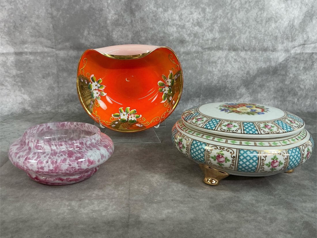 Collectible Glass & Porcelain Dishes: Three mid century pieces. Porcelain round lidded trinket box with floral and gold tone decorations. Orange with painted floral art Bohemian dish, and Murano glass pink and white trinket dish. All in