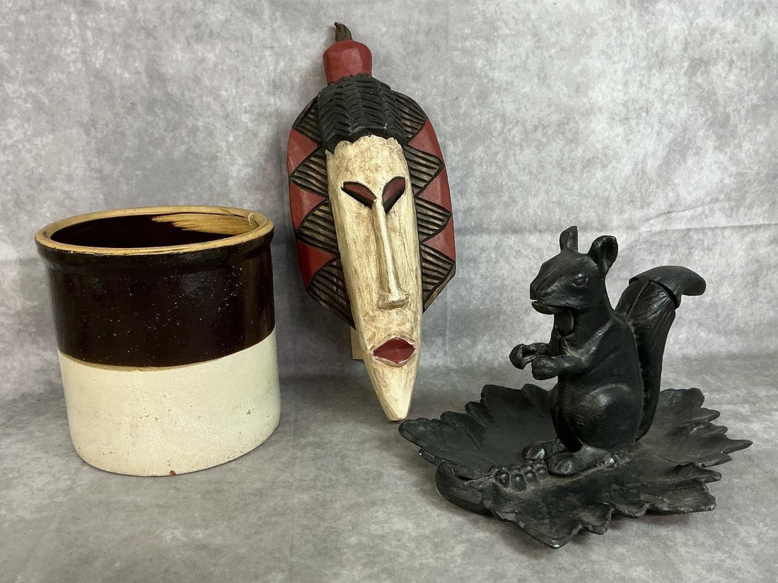 Ghana Mask, Crock, & Nutcracker: Three items from early 1900s to modern age. Hand carved mask from Ghana, West Africa, a two tone stoneware 1 gallon crock, and black aluminum squirrel nutcracker. Crock has crazing and a little paint