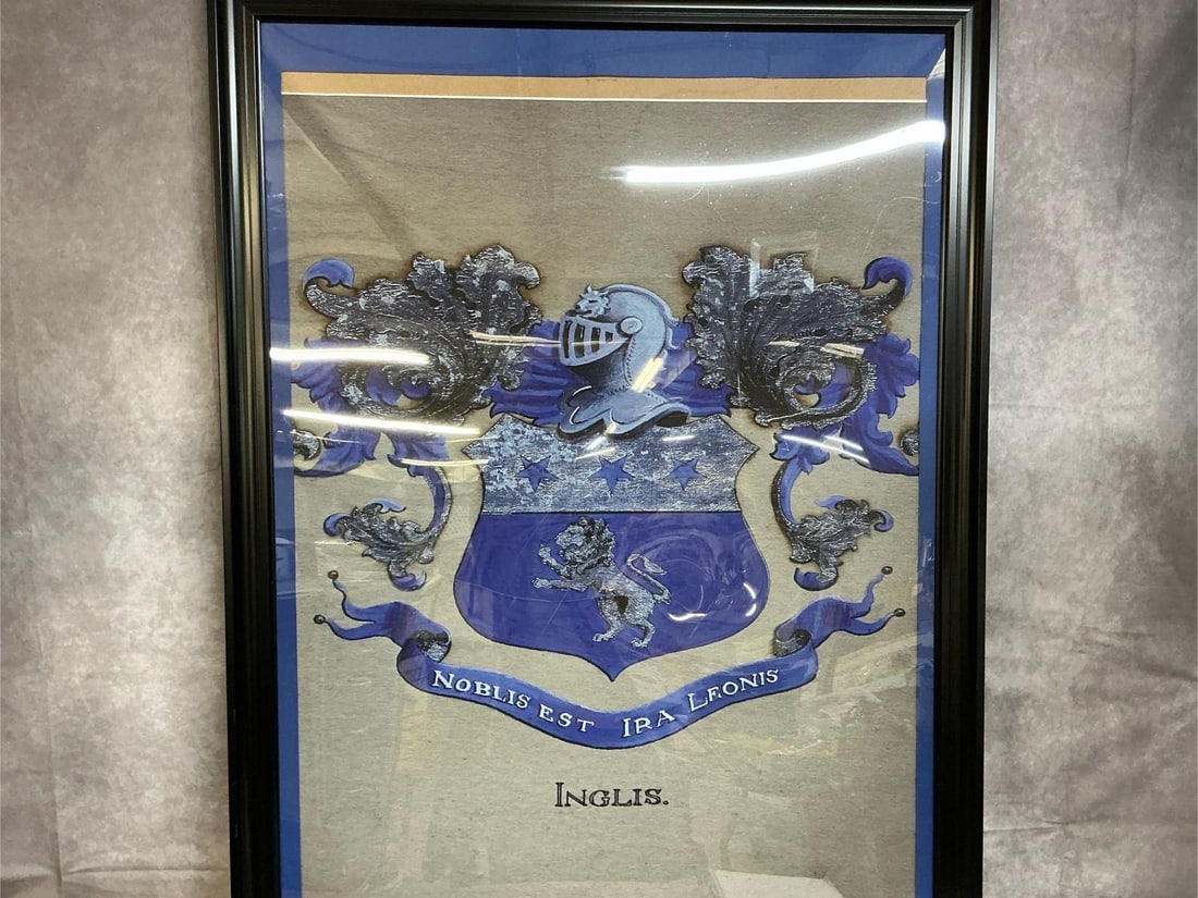 Ingle's Family Coat of Arms & Portrait: Two framed prints from early to mid 1900s. Ingle's family coat of arms on poster with blue mat and plastic frame. Unidentified matted portrait in black plastic frame. Both prints have slid a little