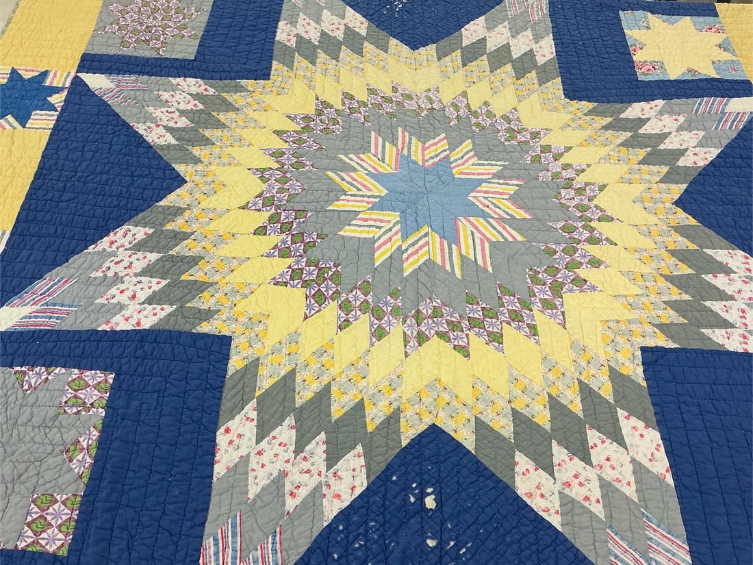 Star Pattern Quilt: Mid century quilt. Hand stitched yellow and blue star design quilt. Assorted cotton fabric with green, red and yellow fabric backing. Some tears and wear. Measures 66 inches wide x 79 inches long.