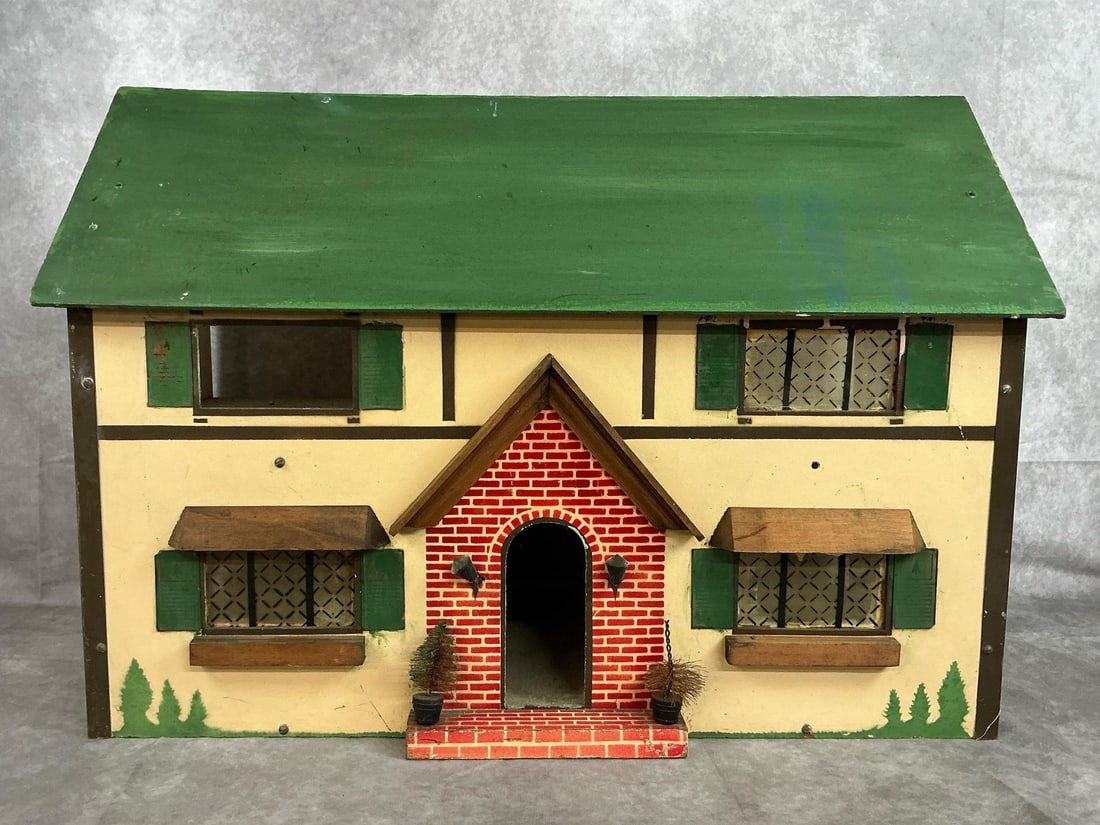 Vintage Doll House: Early century doll house. Wooden and pressboard Tudor style doll house with six rooms. Exterior is green, pale yellow, and brick. Two windows are missing and walls need painting. Measures 24.5 inches