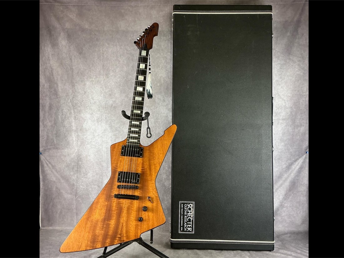 Schecter Diamond Series E-1 Koa Wood Electric Guitar: Schecter Diamond series e-1 explorer body from mahogany and koa top in natural finish six string electric guitar. Two volume/tone knobs, three way selector switch, bridge and neck humbucker pickups, b