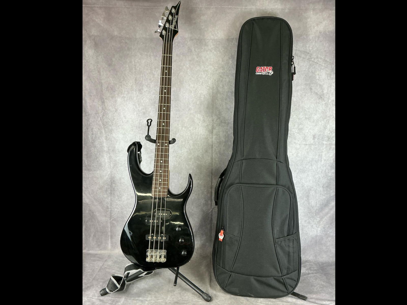 Ibanez Electric Bass: Ibanez double cutaway body from basswood or maple in black gloss finish four string electric bass. Three volume/tone knobs, p/j pickup configuration. Serial number 8903285. Bridge, neck, strings,