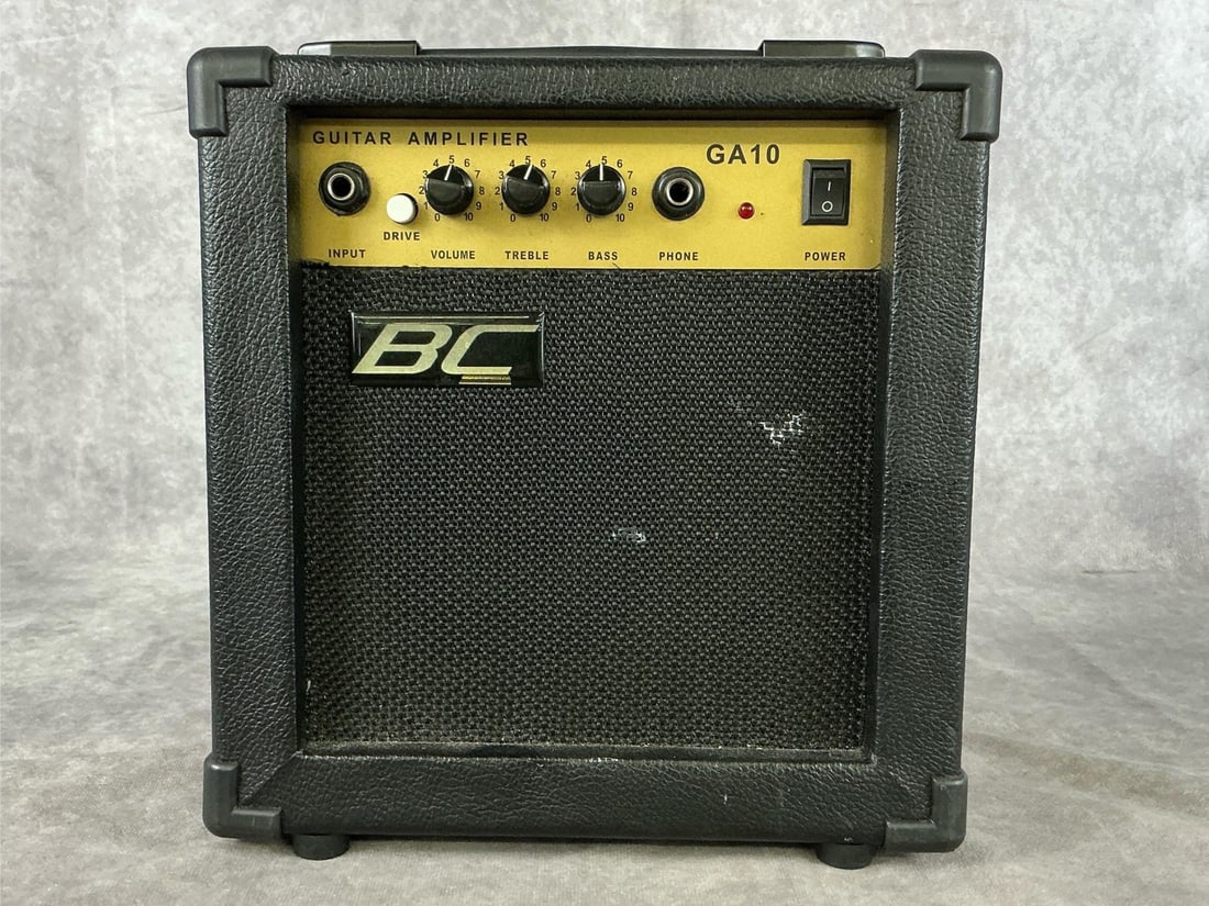 BC GA10 Amp: Model GA10. Serial number not visible. Single input, drive button, volume knob, bass and treble equalizer. Good used condition with wear. Tested, powers on. Measures 10 inches wide x 3 x 10 inches