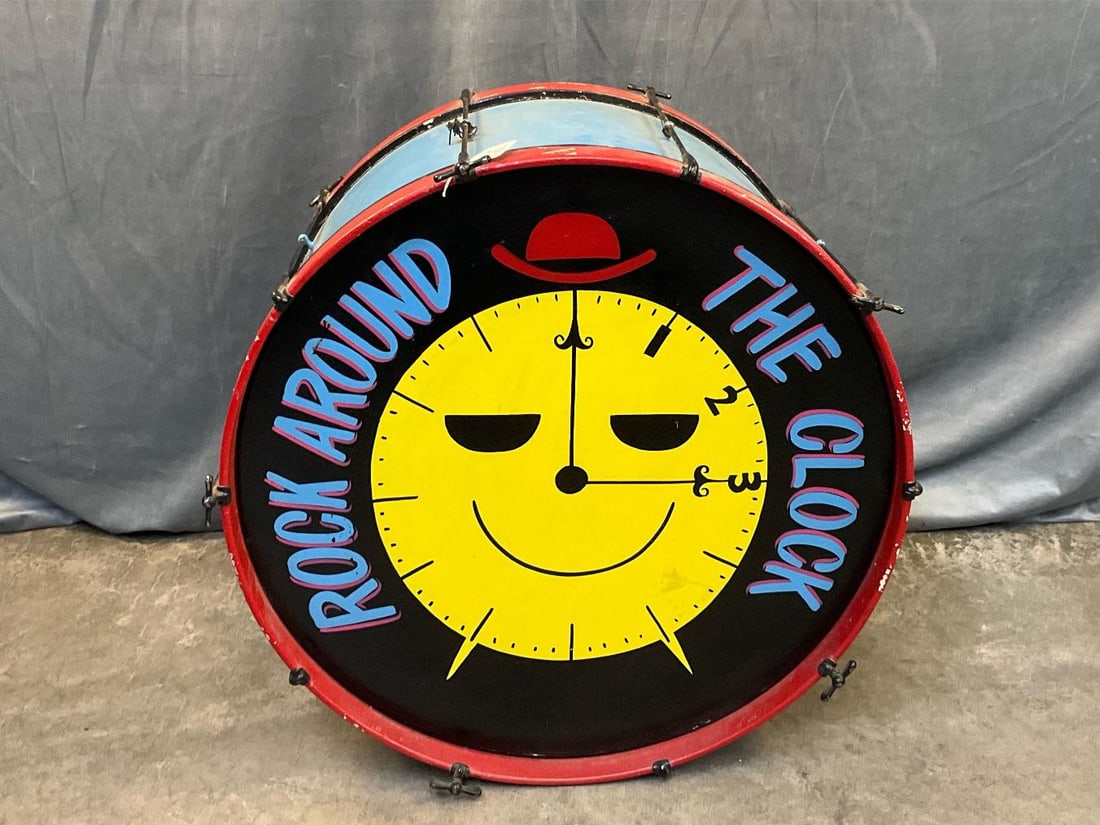 Decorative Painted Bass drum: Mid twentieth century vintage painted “Rock Around The Clock” marching bass drum from Macado’s restaurant. Several scratches to paint, otherwise good condition. Measures 27 inches in diamete