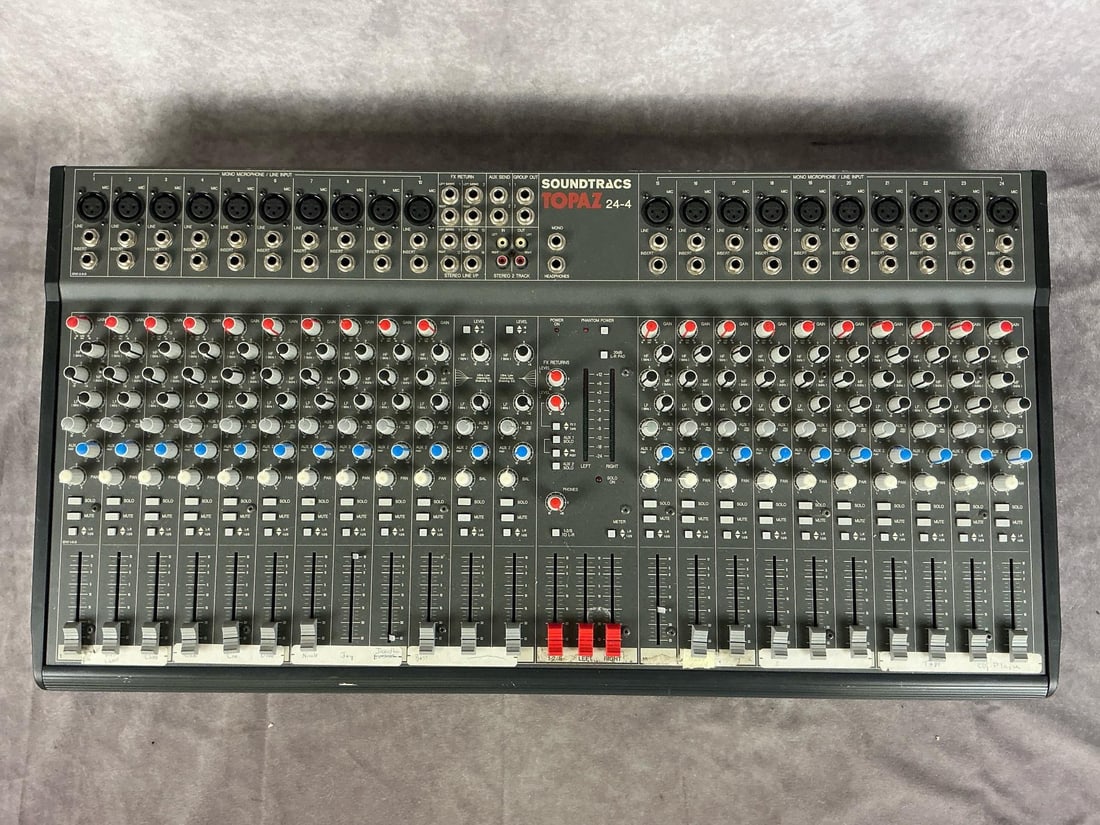 Soundtracs Topaz 24-4 Console Mixer: Model x- tpz-24-4. Serial number 6453099701. 24 channels, two master outputs. Used condition. Untested. Measures 30.5 inches wide x 16 x 3.5 inches tall.