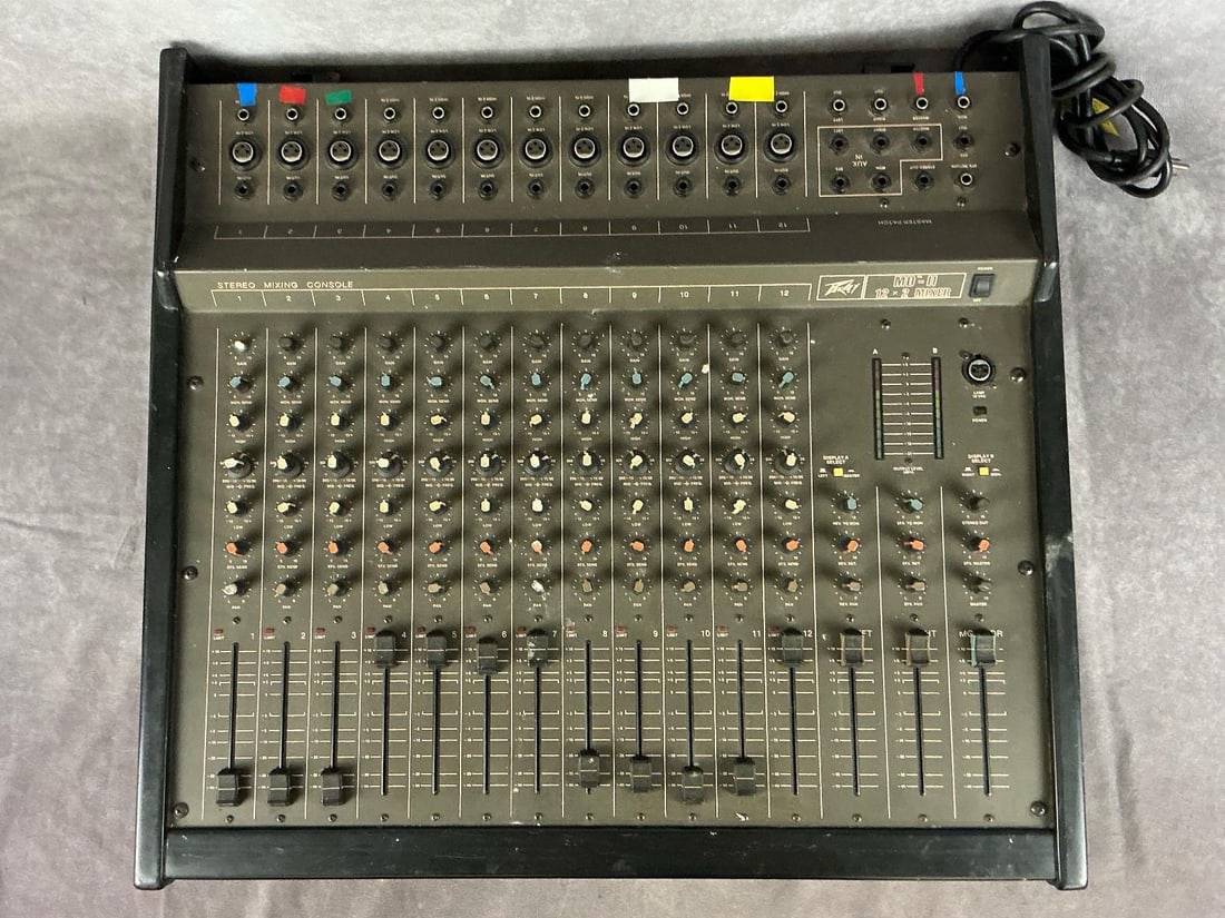 Peavey MD II-12 Audio Mixer: Model md II-12. Serial number 8A-03696498. 12 channels, three pronged XLR in/outputs. Good used condition with minimal wear. Untested. Measures 27.5 inches wide x 25.5 x 5.5 inches tall.