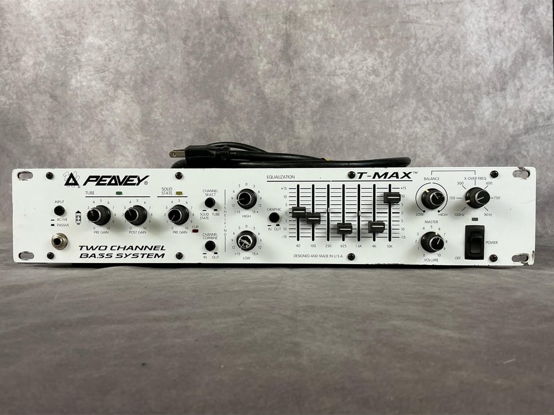Peavey T-Max 2-Channel Bass System: Model t max bass amp head. Serial number 10238902. Three gain knobs, equalizer, balance and volume knobs. Good used condition with wear. Untested. Measures 19 inches wide x 16 x 4 inches tall.