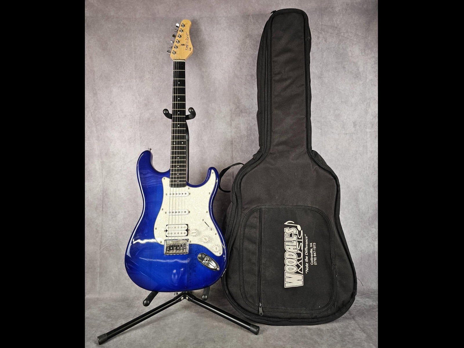 Fretlight 400 Series Guitar: Strat style electric guitar with four way selector switch and three tuning nobs. Soft shell case included. Good condition, with a couple nicks on the back. Measures 13 inches wide x 39 inches long.