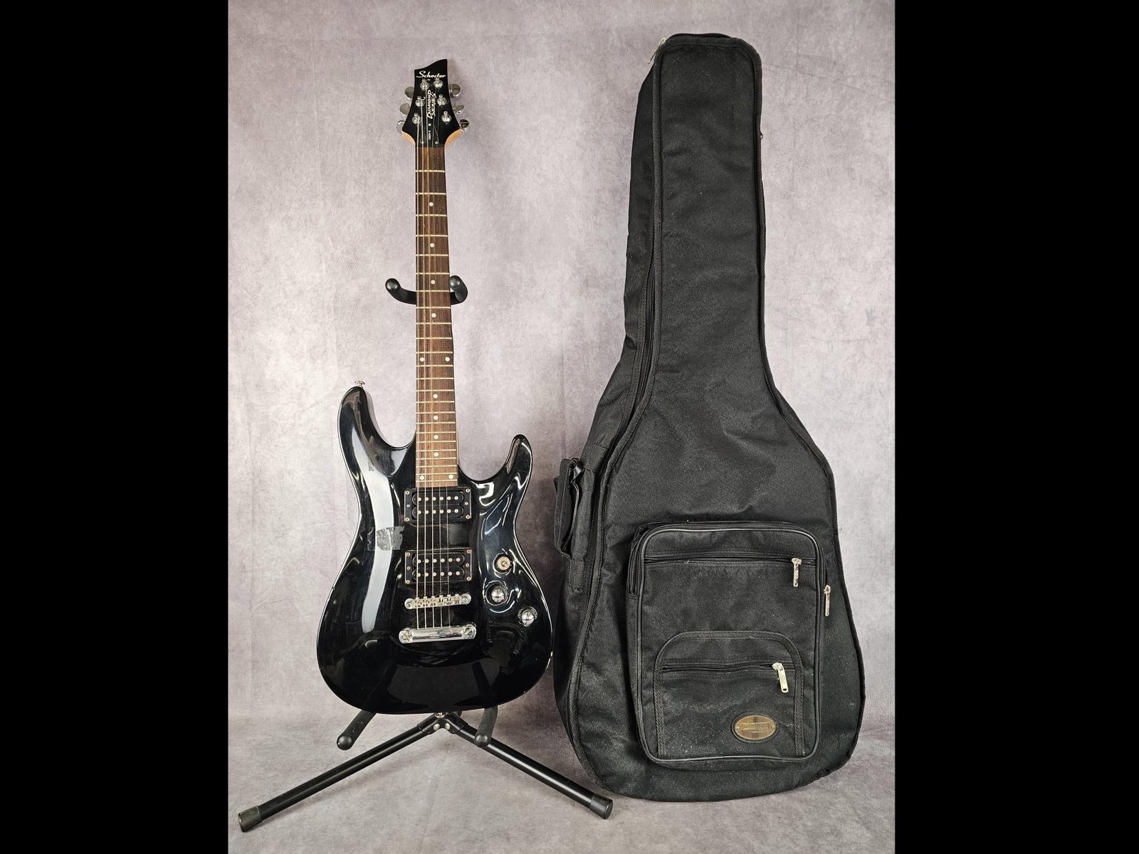 Schecter Diamond Series Guitar: Omen-6 Schecter Diamond series electric guitar with two way selector switch and two tuning nobs. Zip up soft case included. Some rust present on screws and a couple deep scratches on one edge, other