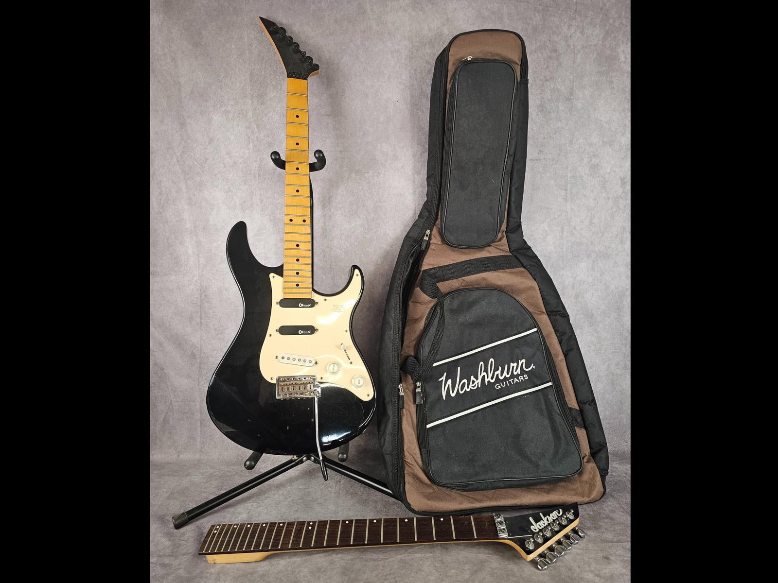 Jackson Electric Guitar: Stratocaster style body Jackson electric guitar with extra neck and Charvel pickups. Four way selector switch and two tuning nobs, soft shell case included. Tape residue on necks, scratches to back,