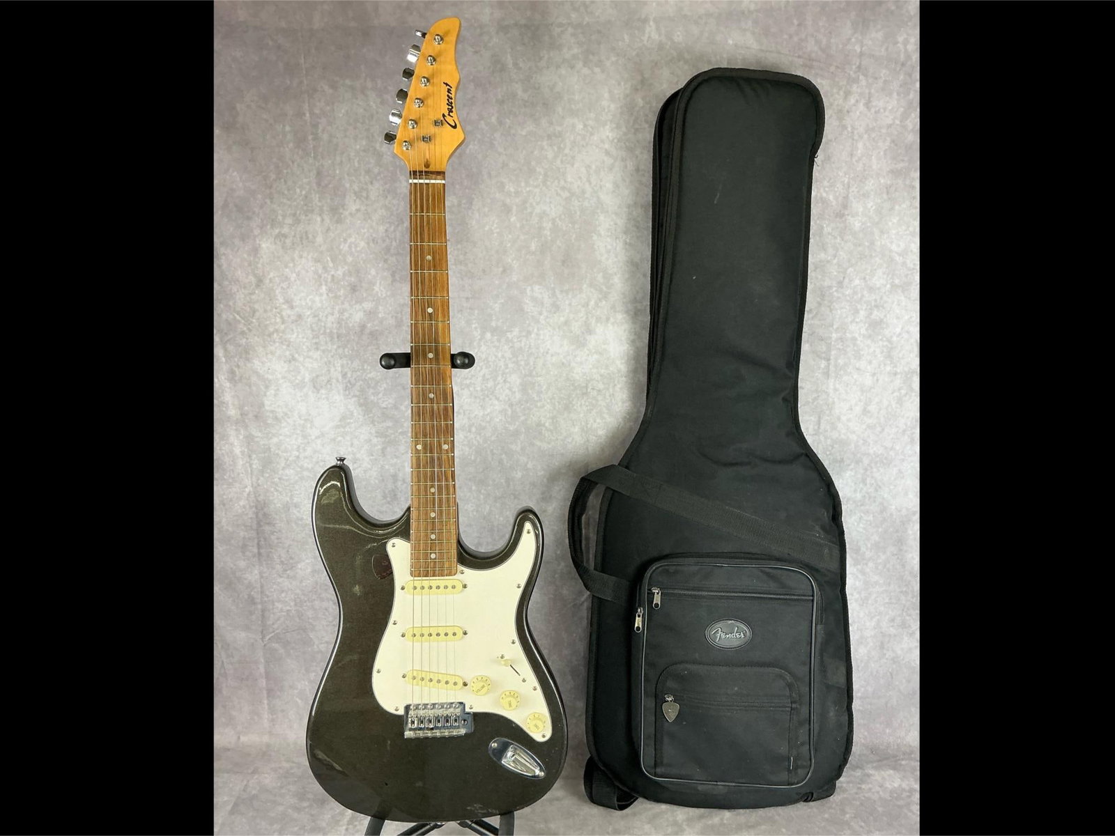 Crescent Stratocaster Electric Guitar: Crescent Stratocaster body from basswood in metallic green finish with white pick guard six string electric guitar. Three volume/tone knobs, five way selector switch, bridge neck and middle single