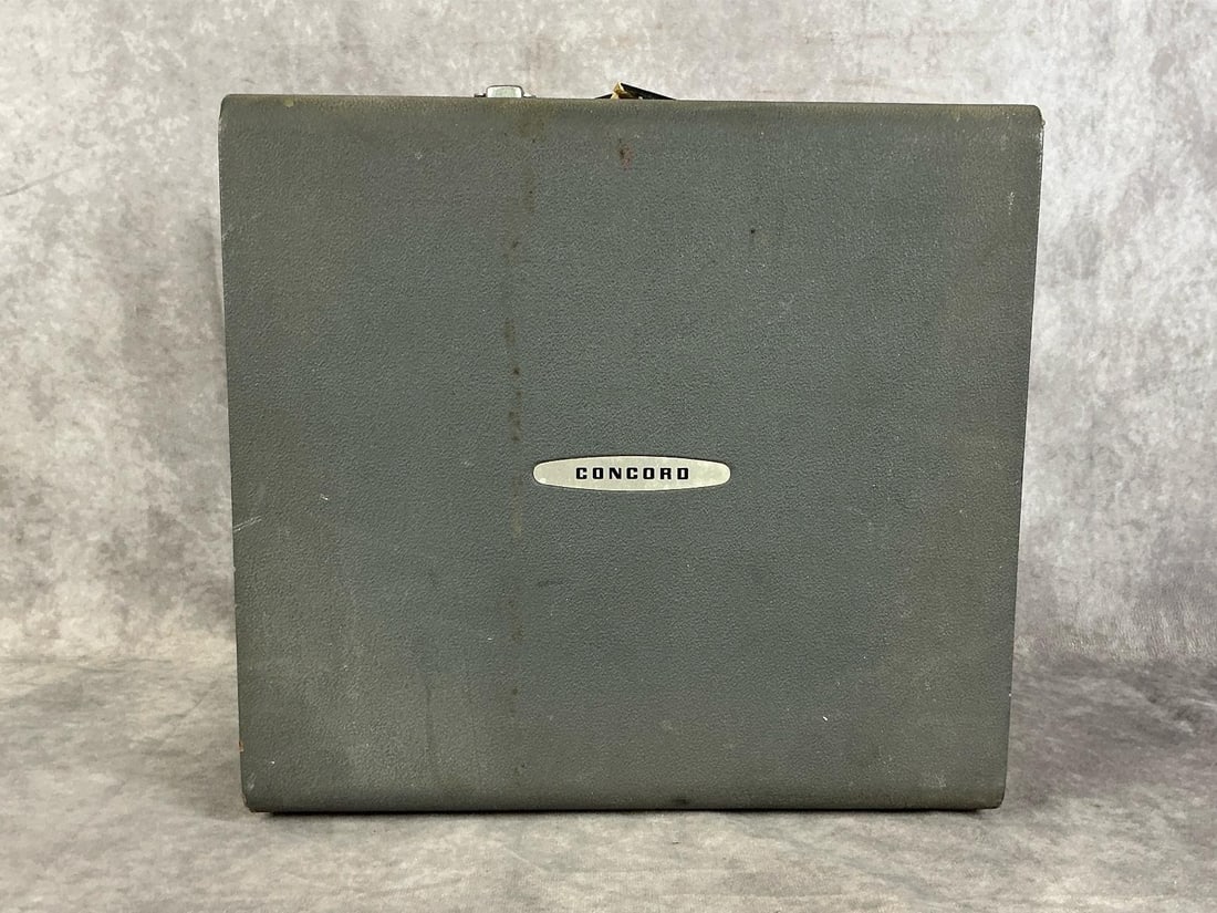 Concord Transistorized 220 Reel to Reel: Model 220T. Serial number 23954. Recording capability, two volume and tone knobs. Good used condition, damaged carrying strap. Untested. Measures 13 inches wide x 12 x 8 inches tall.