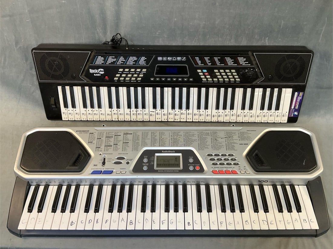 Two Electric Keyboards: RadioShack md-982 and RockJam rj5061. RadioShack serial number 42-4056. Does not include batteries or power cord. Good used condition, untested. RockJam serial number a11220k. Comes with power cord. G