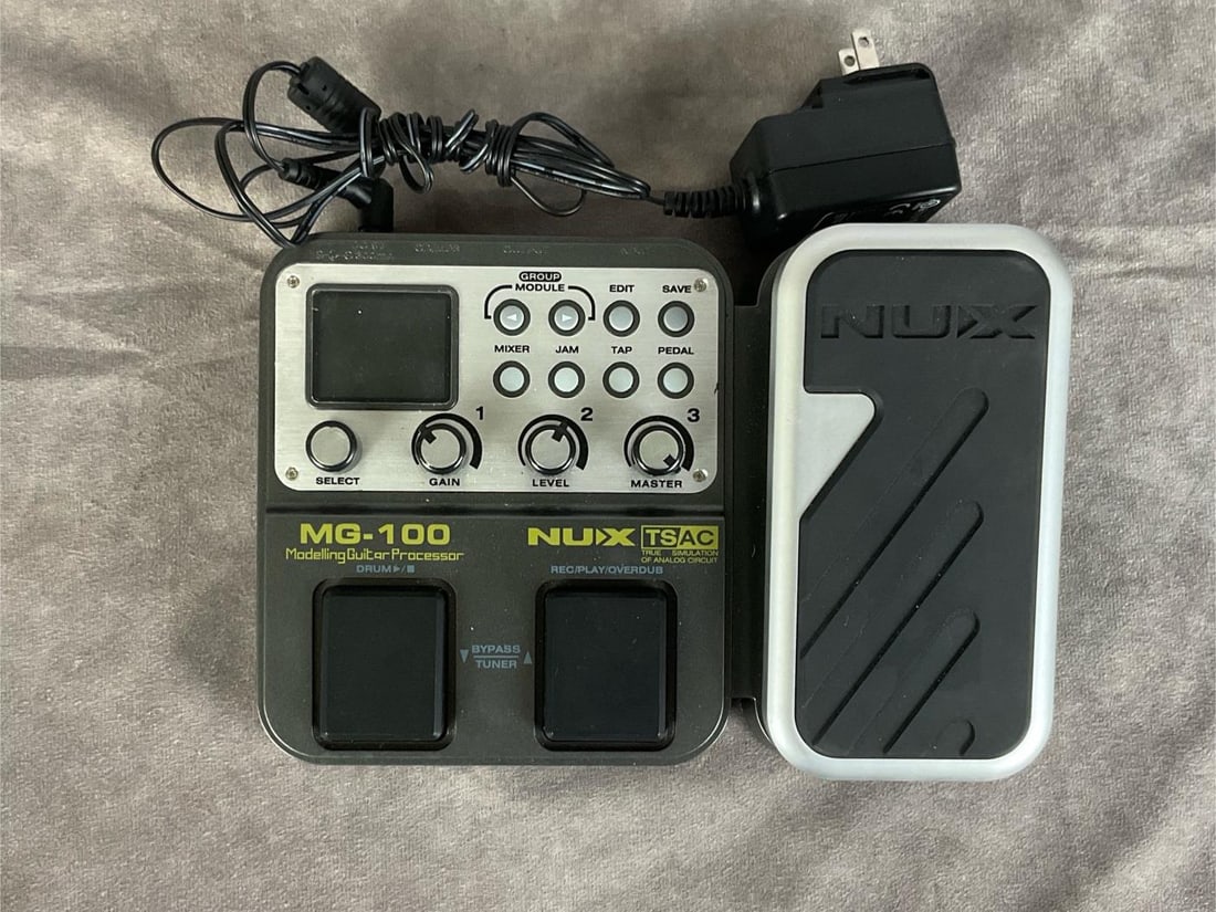 Nux MG-100 Modeling Guitar Processor: Model mg-100. Serial number MG122D22051. Good condition for used, comes with power cord, tested, powers on. Measures 9 inches wide x 6.5 inches long.