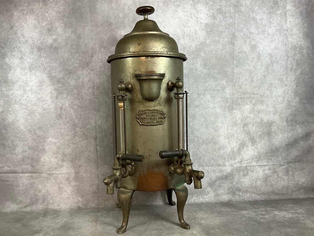 Vintage Metal Coffee Urn: Early 1900's metal Mater & Buttress Company from Washington DC beverage dispenser. Polished metal on ornate legs. Rust and minor oxidation present. Untested. Measures 10 inches in diameter x 29