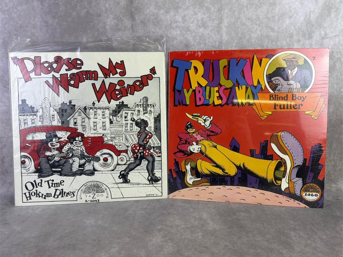1970s Blues Vinyls: Old Time Hokum Blues titled Please warm my weiner and Blind Boy Fuller titled Truckin my blues away vinyls. Both in good condition and sealed in original plastic. Each measures 12.25 inches wide x