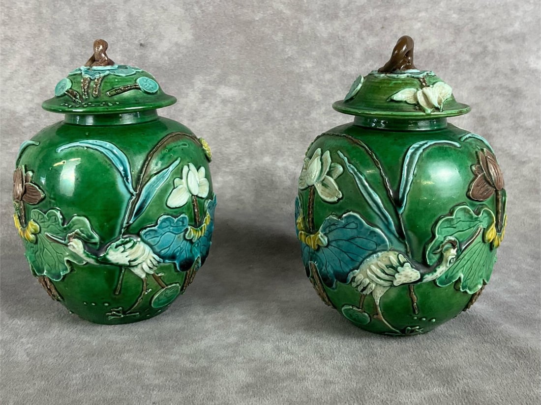 Chinese Sancai Ginger Jars: Applied cranes and lotus, in the style of Wang Bingrong. In good condition. Measures 3 inches wide x 5.5 inches tall.