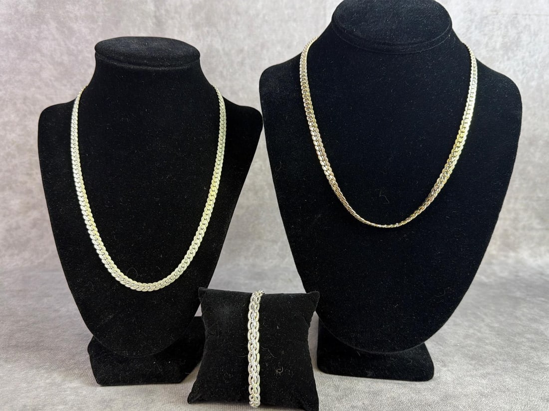 Sterling Silver Jewelry: Lot of sterling silver jewelry including two Cuban link chains and one woven bracelet. All in good condition, stamped with oxidation present. Total weight 2.13 ozt.