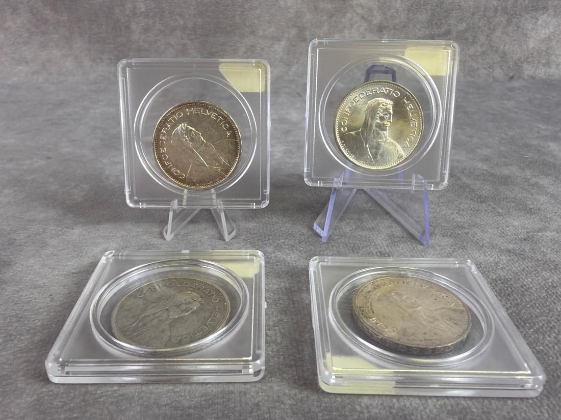 Switzerland Silver Coins: Lot of four Switzerland 5 Francs silver coins dating from 1933 to 1965. All in good circulated condition and containing 80 percent silver. Total weight 1.92 ozt.