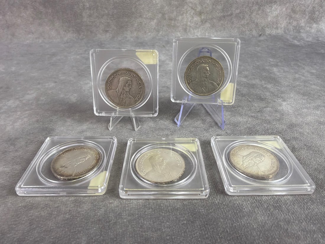 Switzerland Silver Coins: Lot of five Switzerland 5 Francs silver coins dating from 1933 to 1965. All in good circulated condition and containing 80 percent silver. Total weight 2.4 ozt.