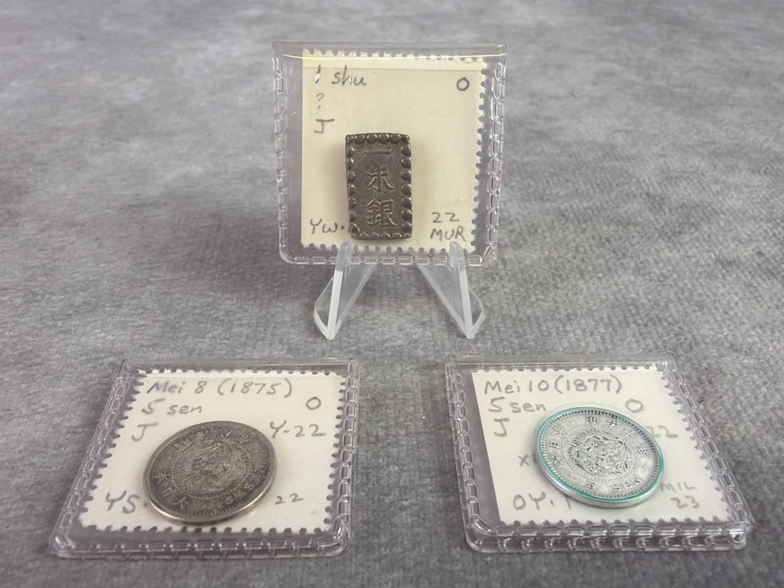 Japanese Currency: One 1603 to 1868 Shu Gin and two 5 Sen from Meji year 8. All in good circulated condition and containing 80 to 90 percent silver. Total weight is 0.19 ozt.