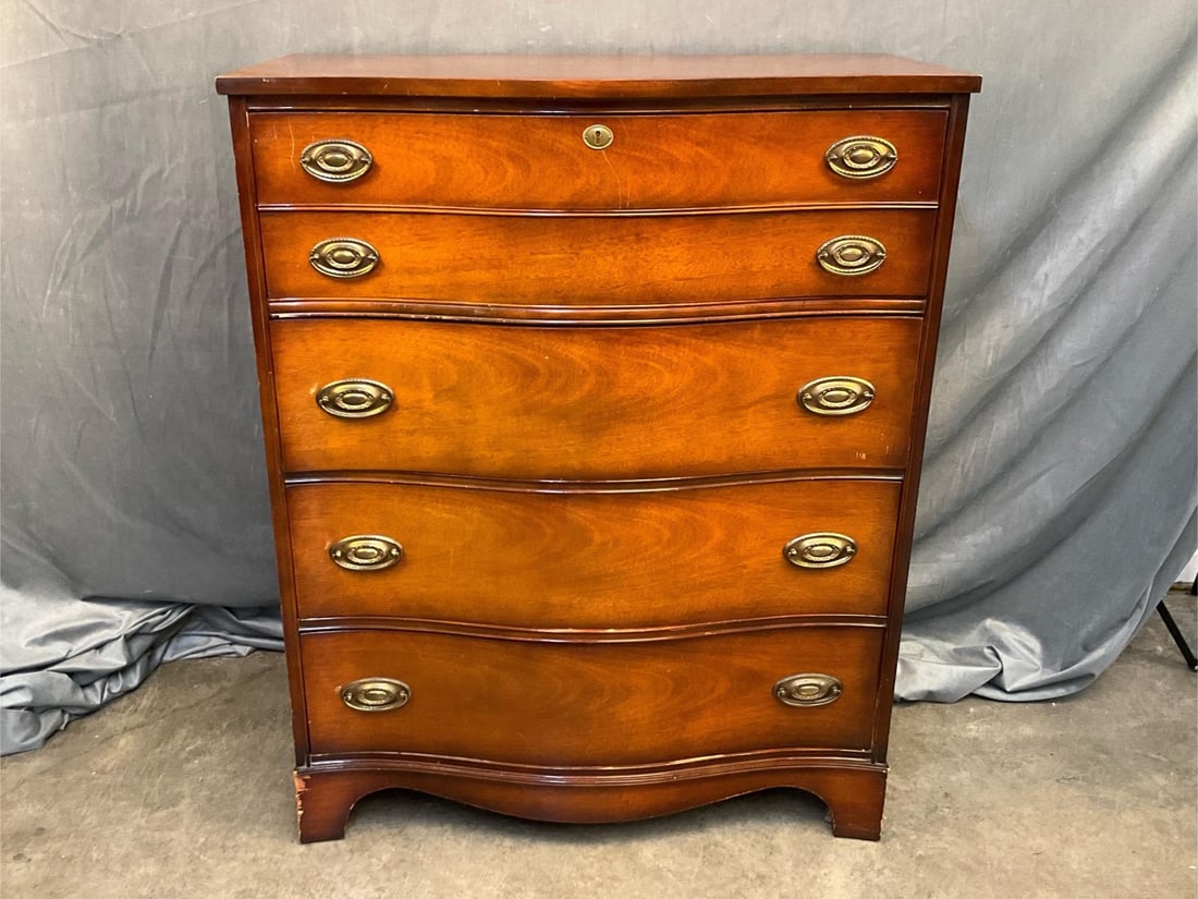 Chest of Drawers: Mid - twentieth century Hepplewhite style mahogany serpentine chest of four drawers made by Bassett Furniture Company. Some minor scratches to finish, otherwise good condition. Measures 36.25 inches