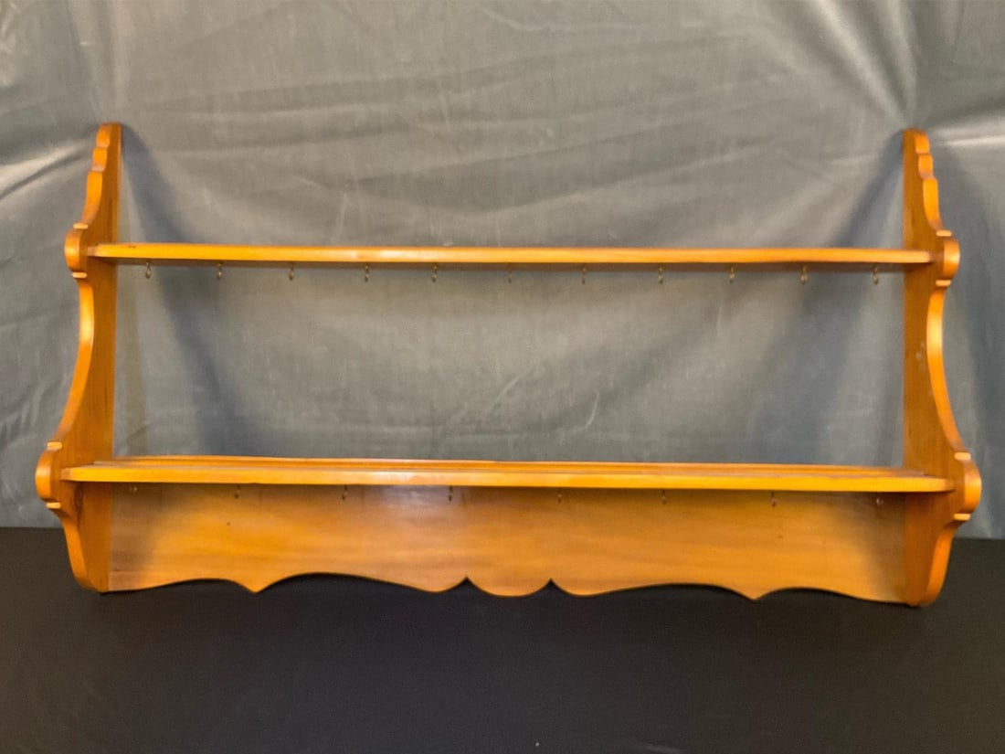 Hanging Shelf Rack: Mid - twentieth century pine wall hanging plate and cup rack with scalloped sides and lower back board, cup hanging hooks underneath shelves. Good condition. Measures 48.5 inches wide x 8 x 27.75